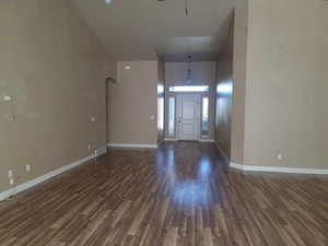 Entrance foyer featuring arched walkways and dark wood-style floors