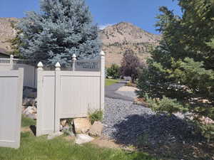 Backyard side gate that accesses the community babbling brook w/walking path on the opposite side. View of mountain backdrop