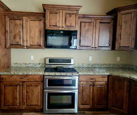 Gas 5-burner range w/double ovens, & black microwave