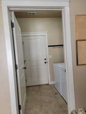 Laundry room with washer and clothes dryer.  Door to Garage & a storage closet opposite the washer/dryer.