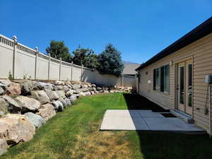 Fenced backyard featuring a patio and a mountain view