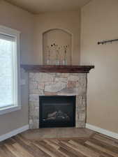Gas Log Fireplace with stone hearth, wood mantel & recessed area.