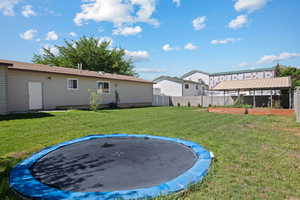 View of yard with a trampoline