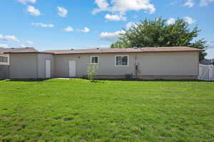 Rear view of house featuring a gate
