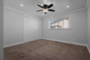 Unfurnished bedroom featuring crown molding, carpet, a closet, ceiling fan, and recessed lighting