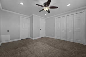 Unfurnished bedroom featuring carpet floors, ornamental molding, recessed lighting, ceiling fan, and a closet