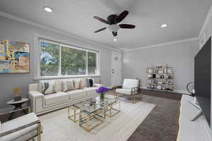 Living room with crown molding, a textured ceiling, ceiling fan, and recessed lighting