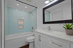 Bathroom with  shower combination, vanity, crown molding, dark wood finished floors, and recessed lighting