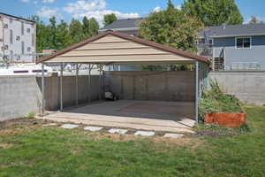 View of parking with a carport