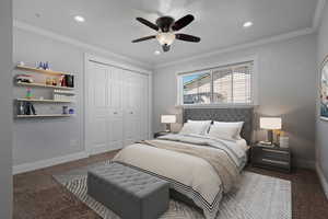 Carpeted bedroom with ornamental molding, a closet, a ceiling fan, and recessed lighting