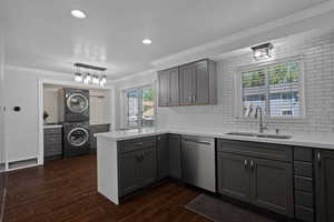 Kitchen featuring ornamental molding, gray cabinetry, a peninsula, a textured ceiling, and dishwasher