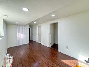 Spare room with a textured ceiling, wood finished floors, and recessed lighting