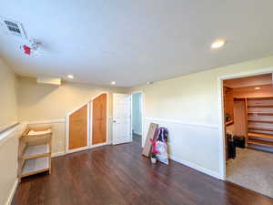 Bonus room with recessed lighting, wood finished floors, and a textured ceiling
