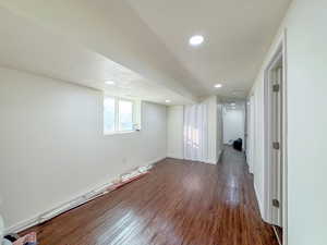Below grade area featuring a textured ceiling, wood finished floors, and recessed lighting
