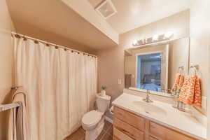 Basement Full Bathroom featuring tile patterned flooring, vanity, and a shower with curtain