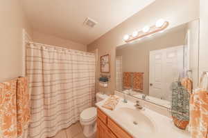 Bathroom with vanity, tile patterned floors, and a shower with curtain