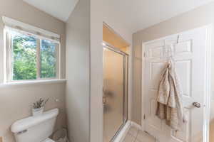 Primary Bathroom with shower and tile patterned floors