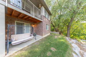 Walkout basement patio with view of creek below