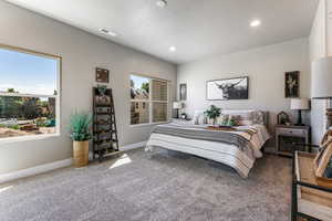 Carpeted bedroom with recessed lighting and a textured ceiling