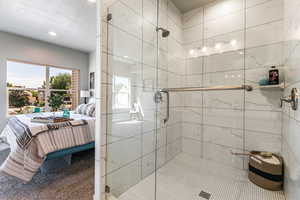 Full bathroom with ensuite bathroom, a shower stall, and recessed lighting