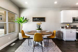 Dining room with recessed lighting, a textured ceiling, and dark wood-style floors