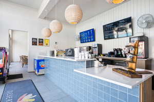 Kitchen featuring tile patterned flooring and hanging light fixtures