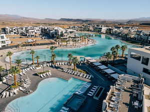 Aerial view of residential area featuring a mountainous background and a pool