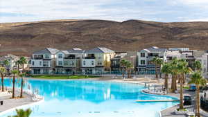 Community pool featuring a residential view and a mountain view