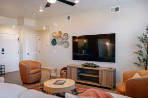 Living room featuring wood finished floors, recessed lighting, a textured ceiling, and ceiling fan