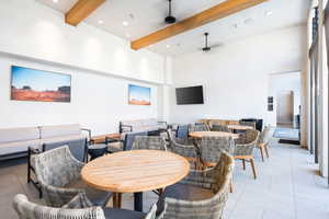 Dining room featuring beamed ceiling, a towering ceiling, recessed lighting, and light tile patterned floors