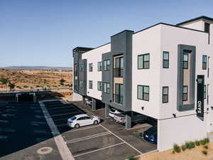 View of property featuring uncovered parking