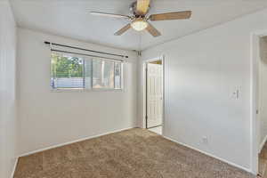2nd bedroom with light carpet and a ceiling fan with access to the Jack and Jill bathroom