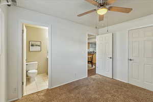 2nd bedroom with light carpet and a ceiling fan with access to the Jack and Jill bathroom