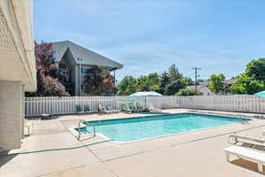 Community pool with a patio
