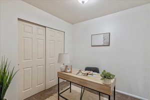 Office with light carpet and baseboards