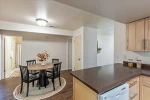 Dining area with dark wood-style flooring