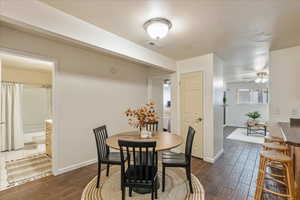 Dining space with wood tiled floors, ceiling fan, and a textured ceiling