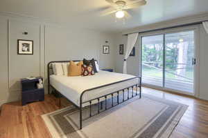 Bedroom with access to exterior, light wood-style flooring, crown molding, and ceiling fan