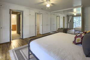 Bedroom featuring hardwood / wood-style floors, ornamental molding, and a ceiling fan