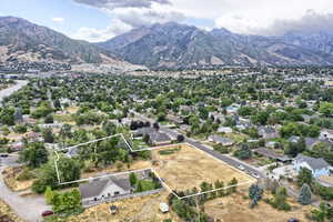 Aerial view of residential area featuring property parcel outlined and mountains