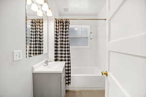 Bathroom featuring vanity and shower / tub combo