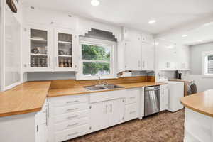 Kitchen featuring washing machine and dryer, plenty of natural light, light countertops, dishwasher, and recessed lighting