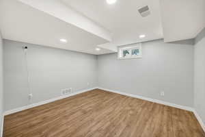 Below grade area with wood finished floors and recessed lighting