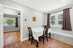 Dining space with healthy amount of natural light and wood-type flooring