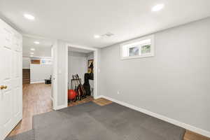 Workout room featuring wood finished floors and recessed lighting