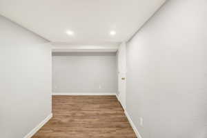 Hallway featuring wood finished floors and recessed lighting