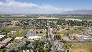 Aerial view of property and surrounding area featuring nearby suburban area