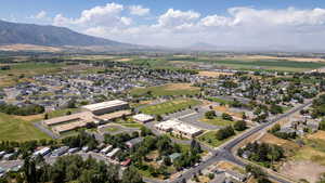 Aerial view of property's location featuring nearby suburban area and a mountain backdrop