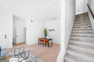 Stairway with recessed lighting and wood finished floors