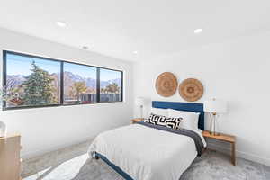 Bedroom featuring a mountain view, recessed lighting, and carpet
